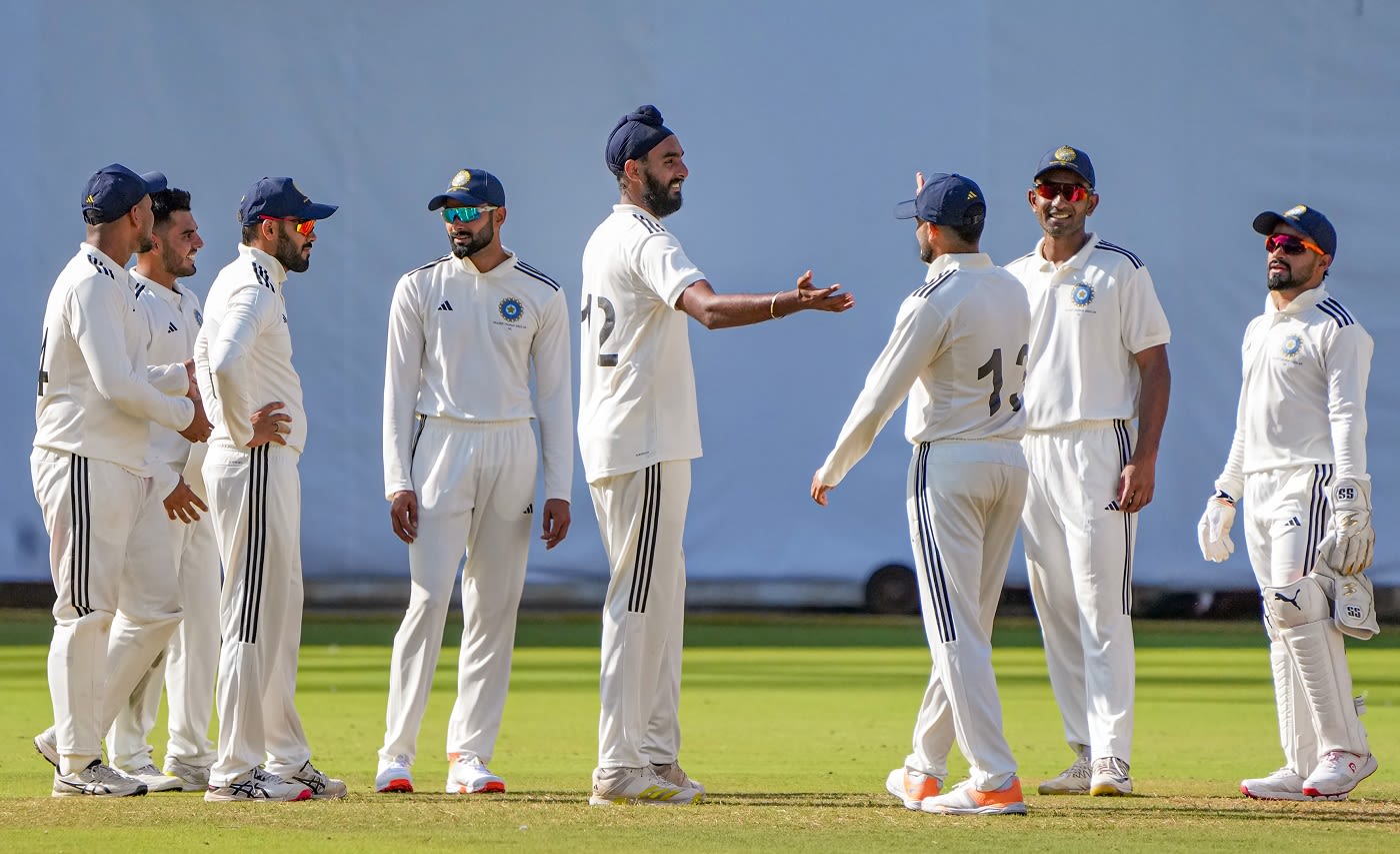 Team-mates surround Baltej Singh after he got a wicket