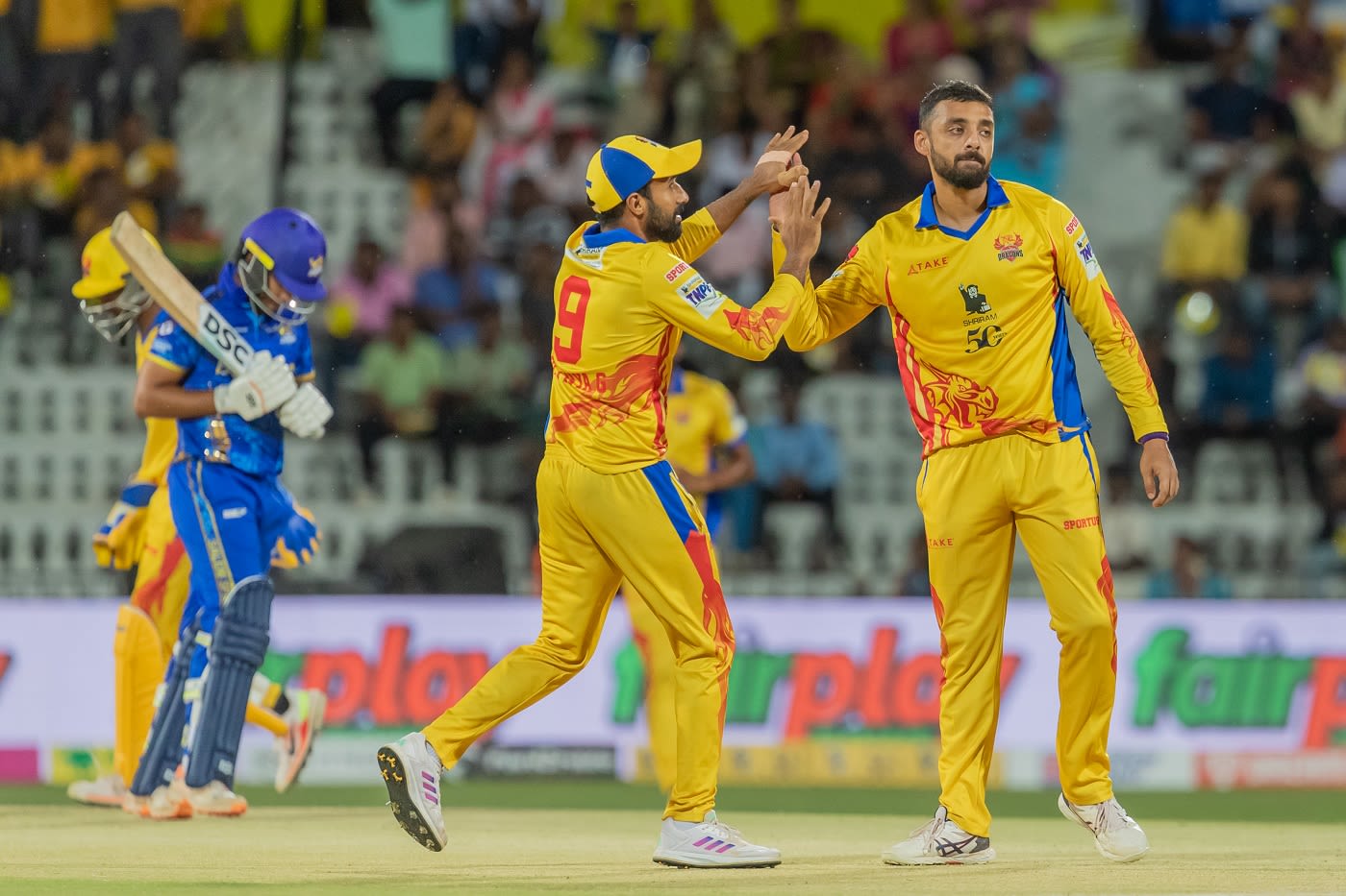 Varun Chakravarthy celebrates a wicket with Adithya Ganesh