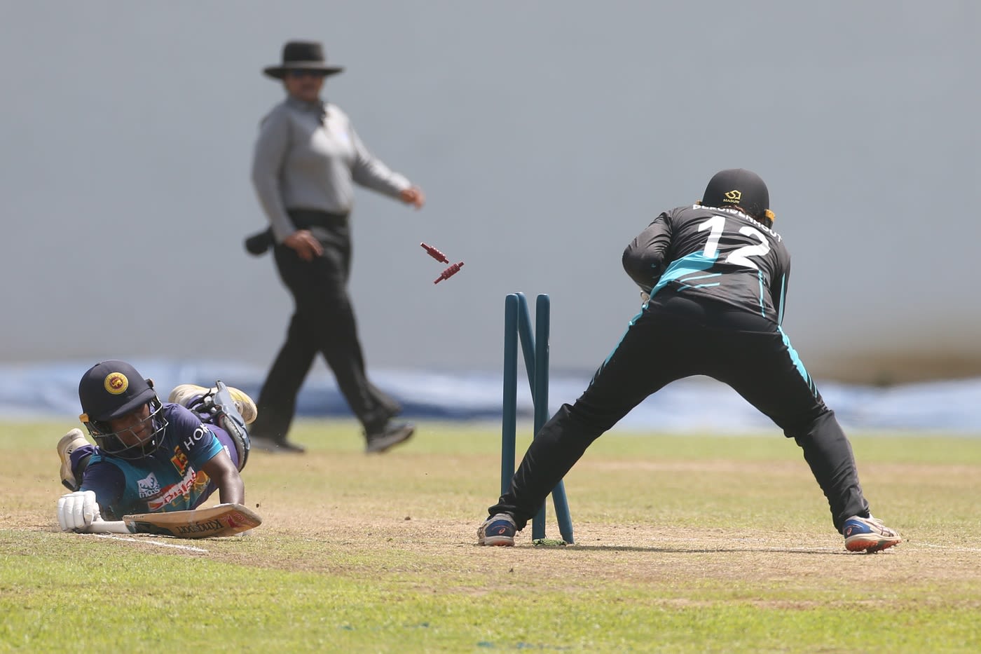 Hansima Karunaratne dives with Bernadine Bezuidenhout attempting a run-out