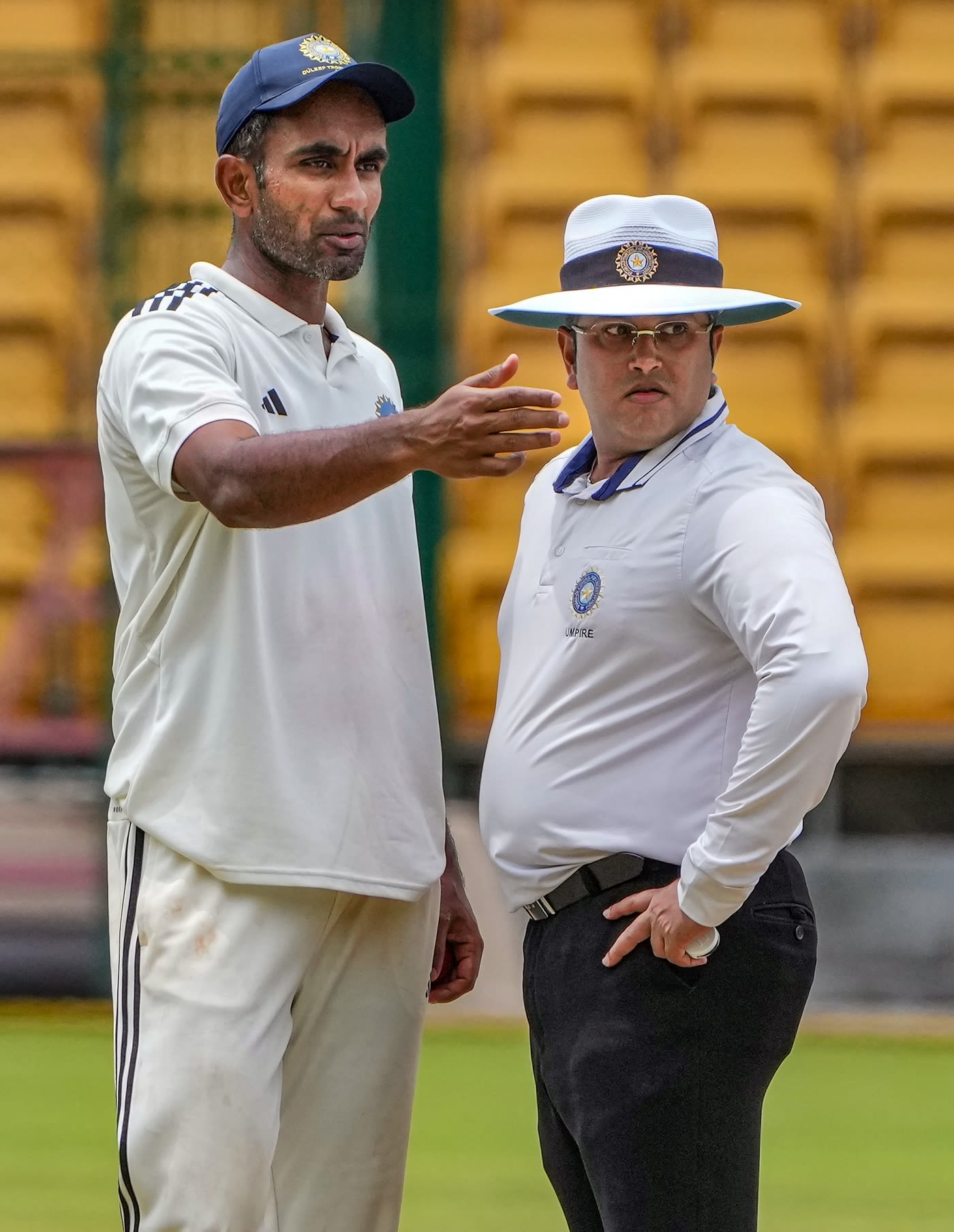 North Zone captain Jayant Yadav has a chat with umpire Rohan Pandit