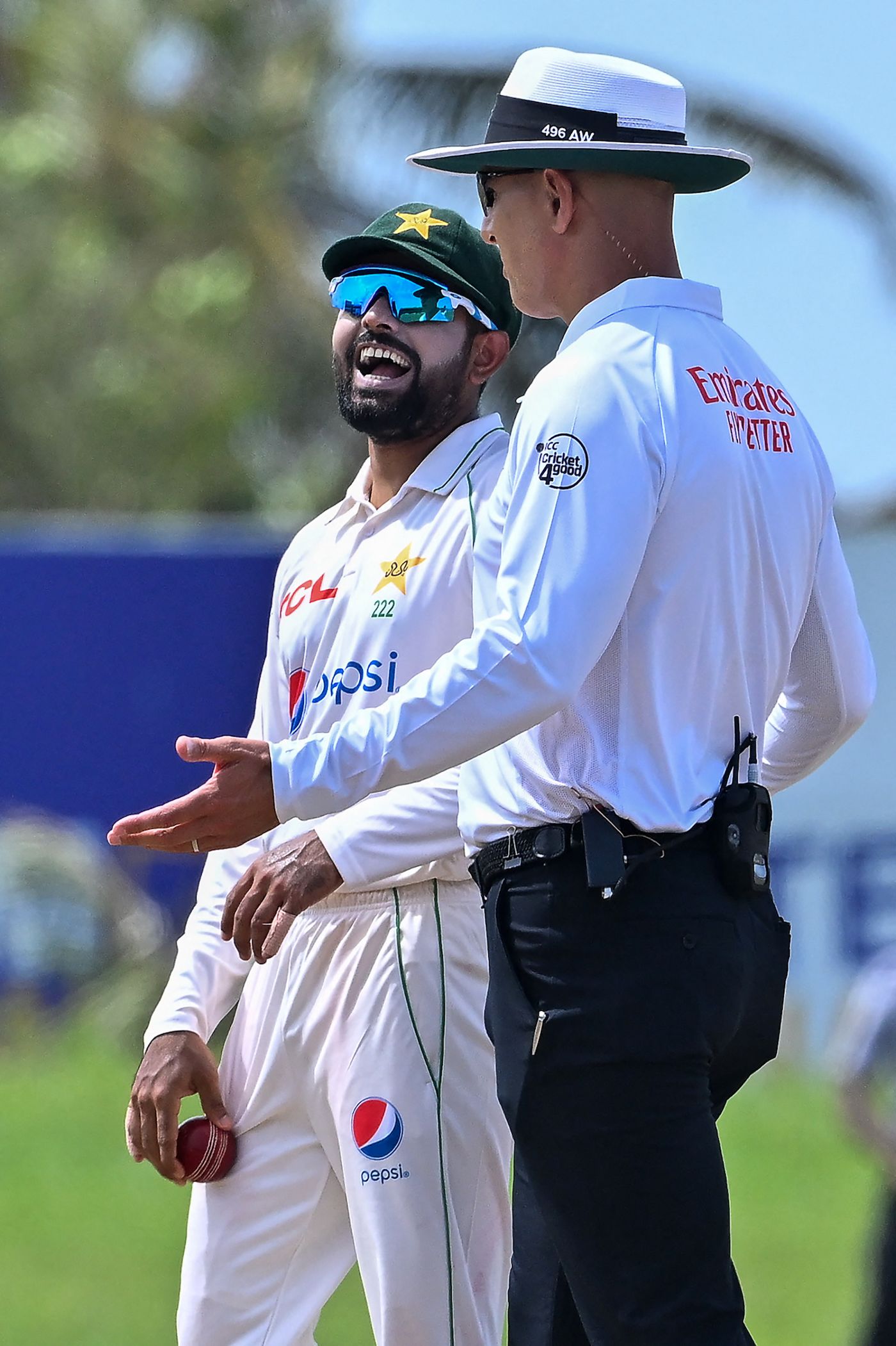 Babar Azam shares a laugh with umpire Alex Wharf