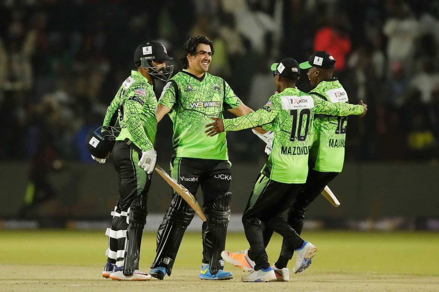 Hazratullah Zazai and Asif Ali celebrate with team-mates after taking Durban Qalandars to a win