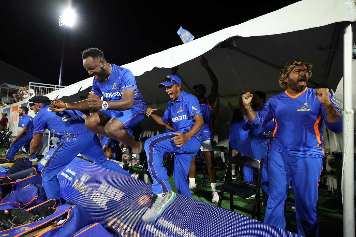 Kieron Pollard and Lasith Malinga lead the celebrations in the MI New York dugout