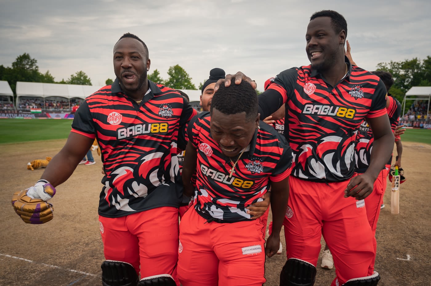 Sherfane Rutherford is congratulated by Andre Russell and Carlos Brathwaite after winning the final