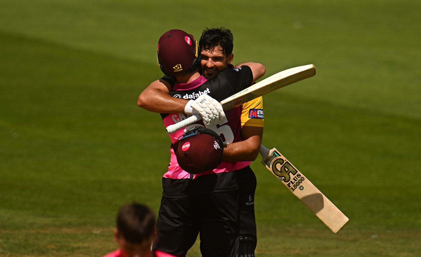 Andrew Umeed celebrates his century with team-mate Curtis Campher