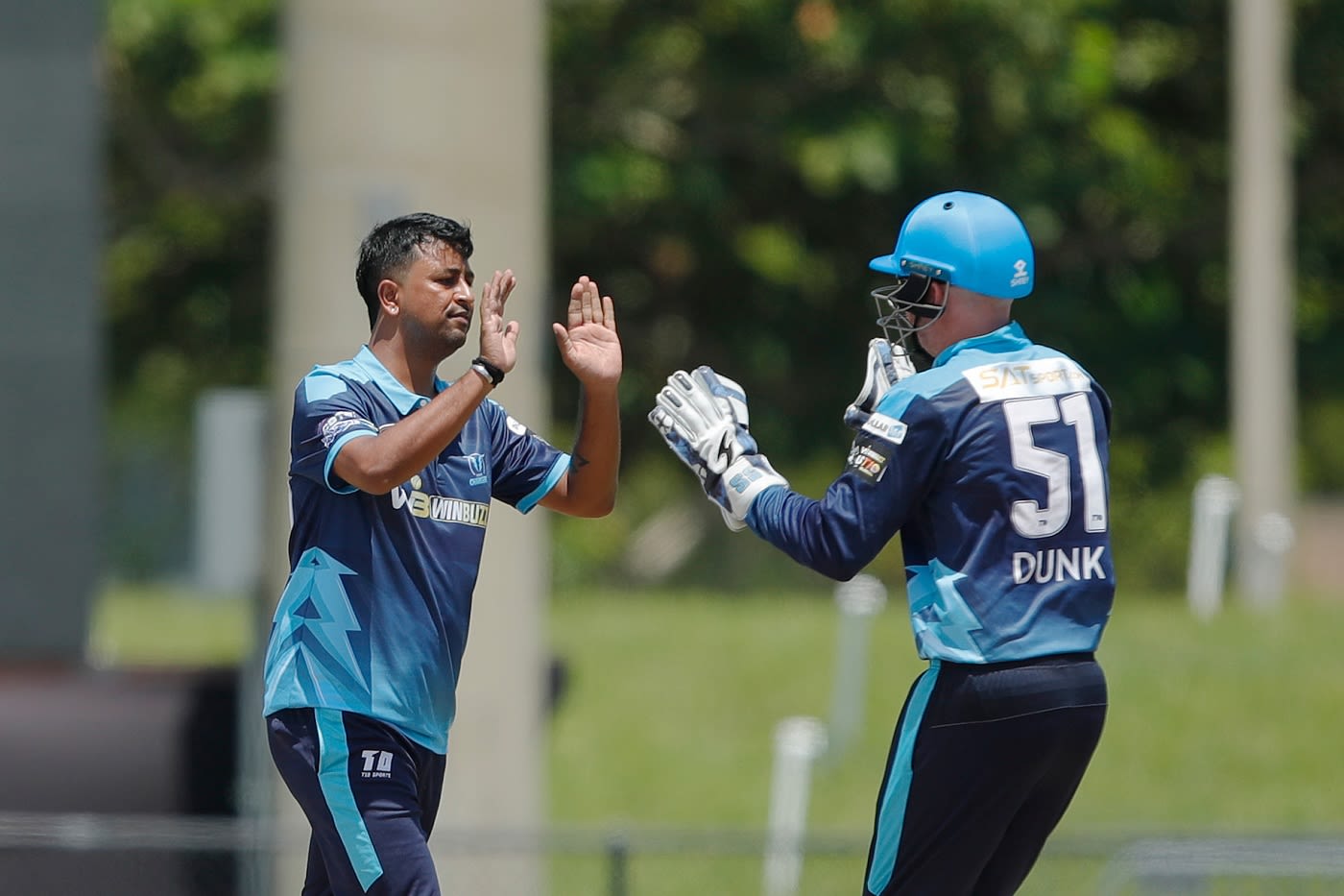 Pragyan Ojha and Ben Dunk celebrate a wicket