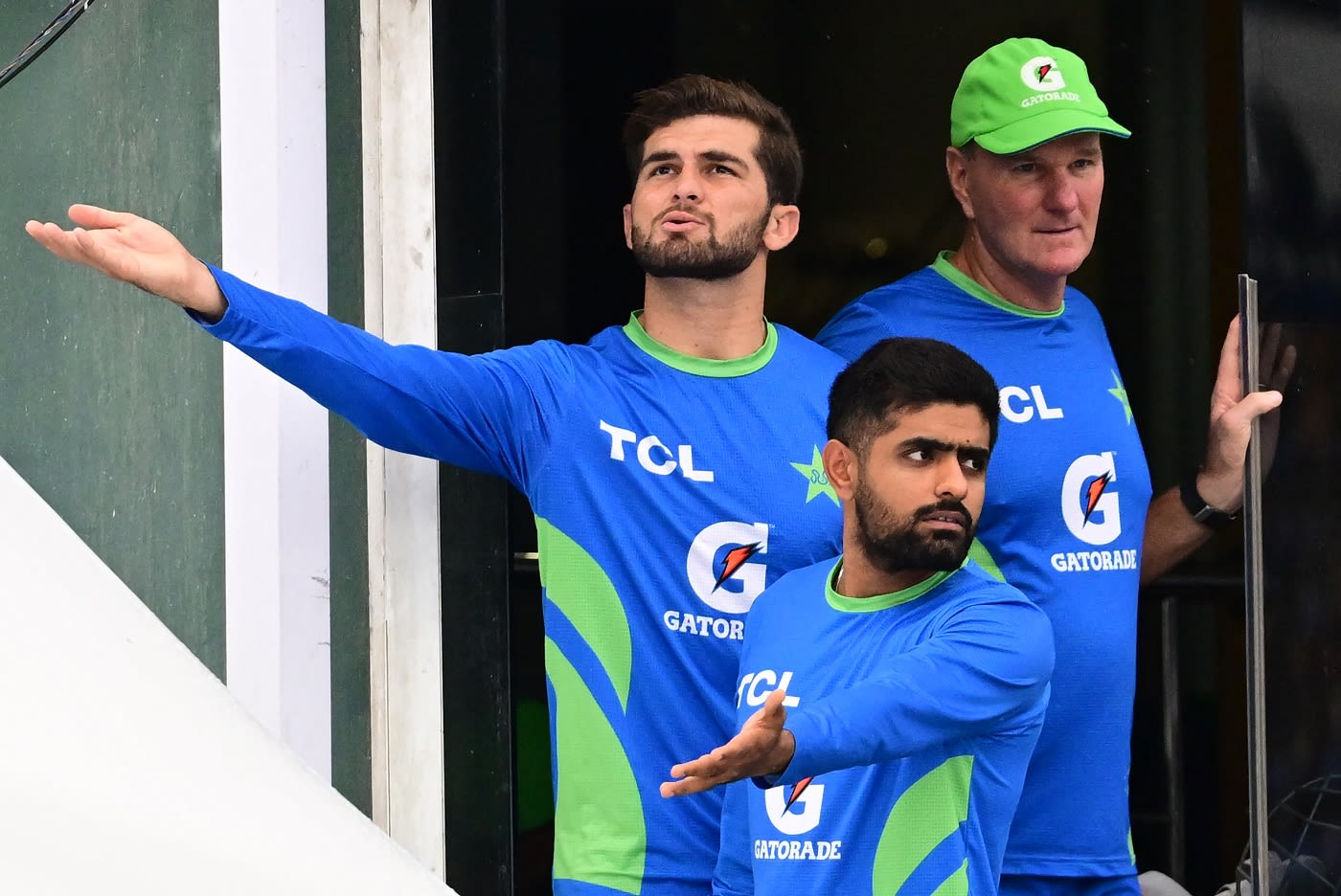 Shaheen Shah Afridi, Babar Azam and Grant Bradburn check if the rain has stopped