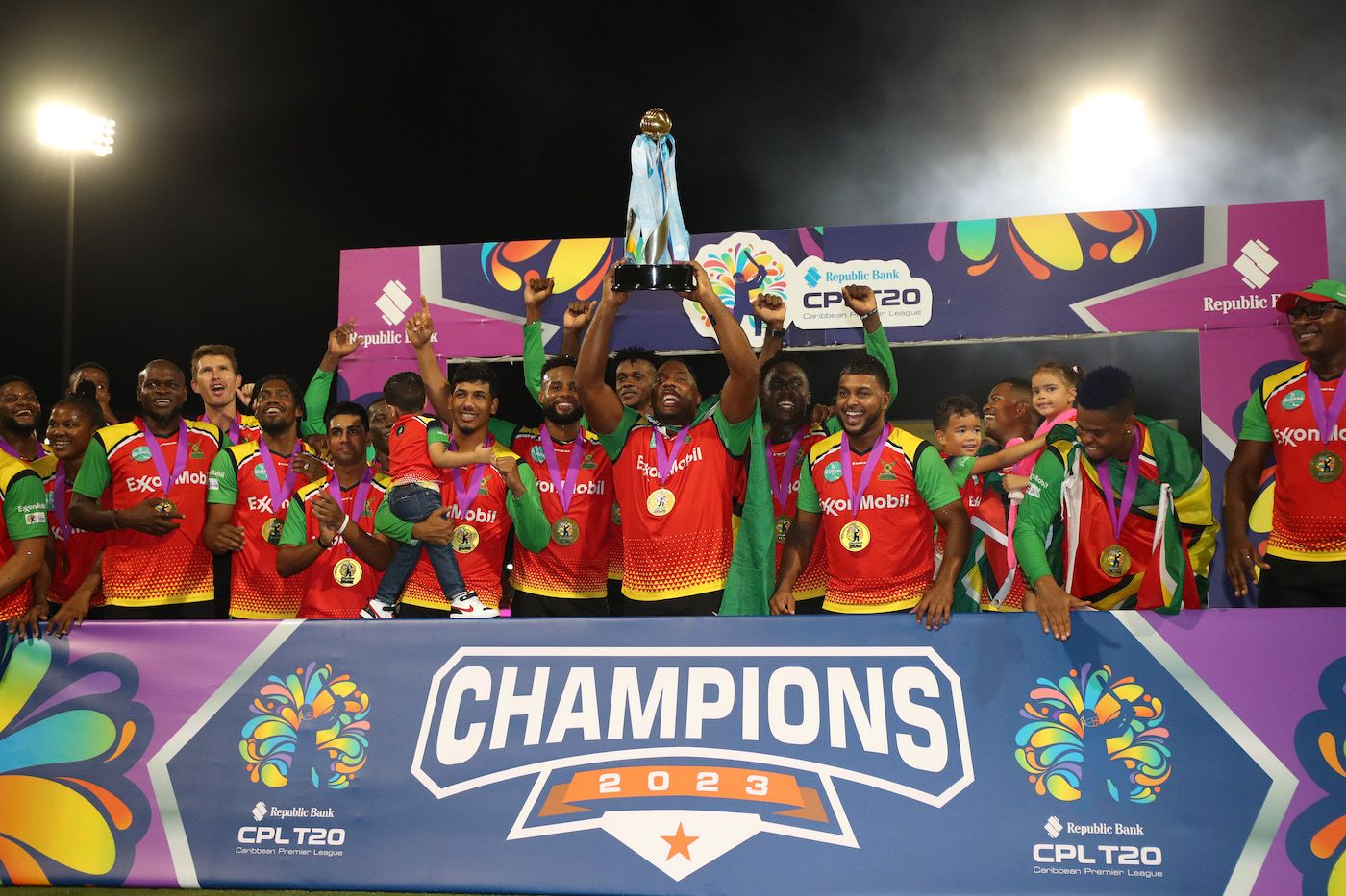 Guyana Amazon Warriors players gather around Odean Smith to celebrate their win