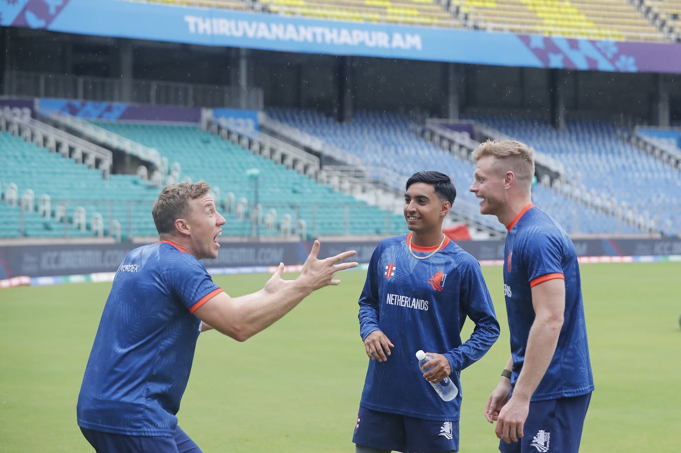 Logan van Beek makes a point to Shariz Ahmad and Sybrand Engelbrecht even as drizzle continued