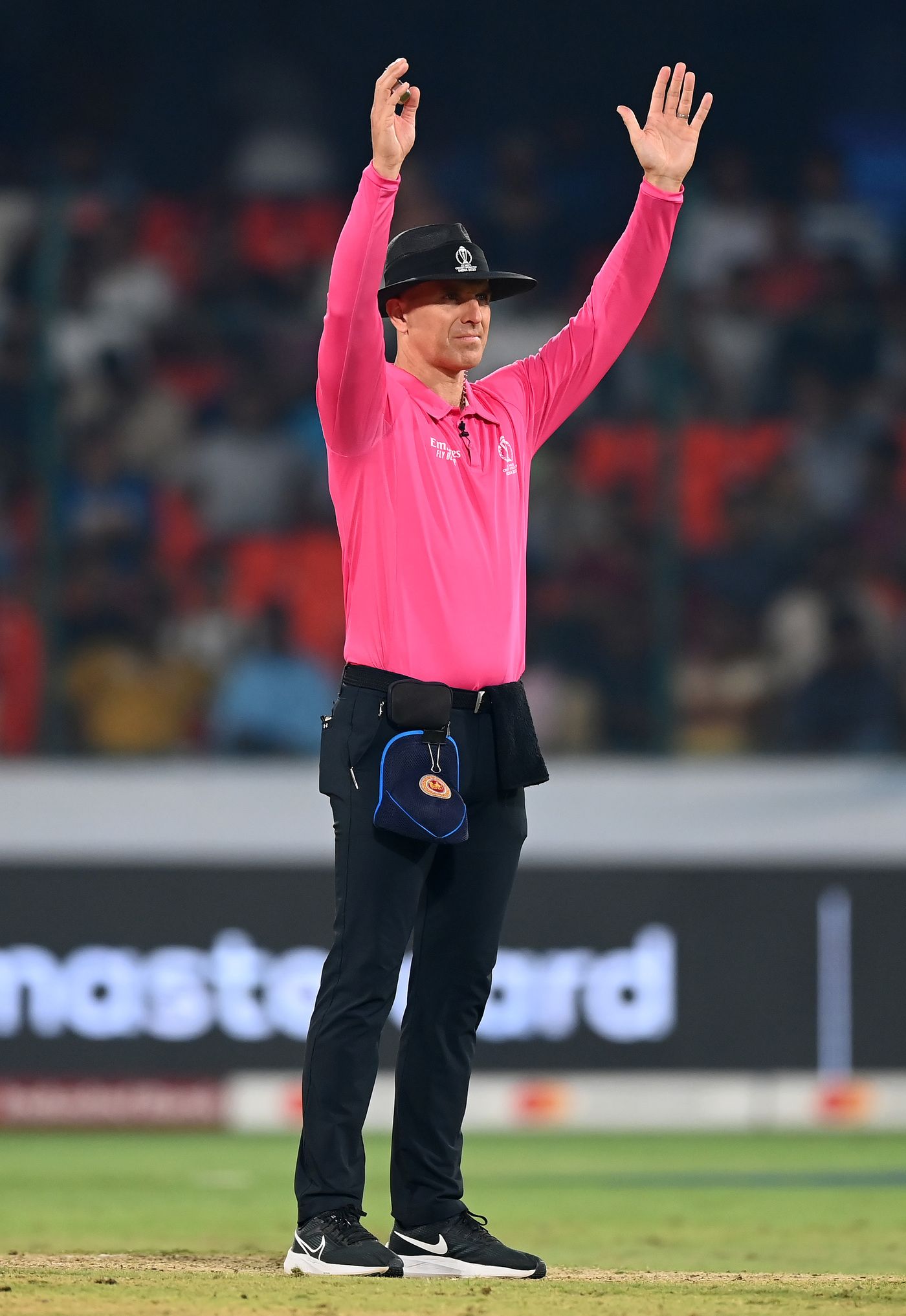 It's a six! Umpire Alex Wharf brings out the signal bowlers everywhere dread