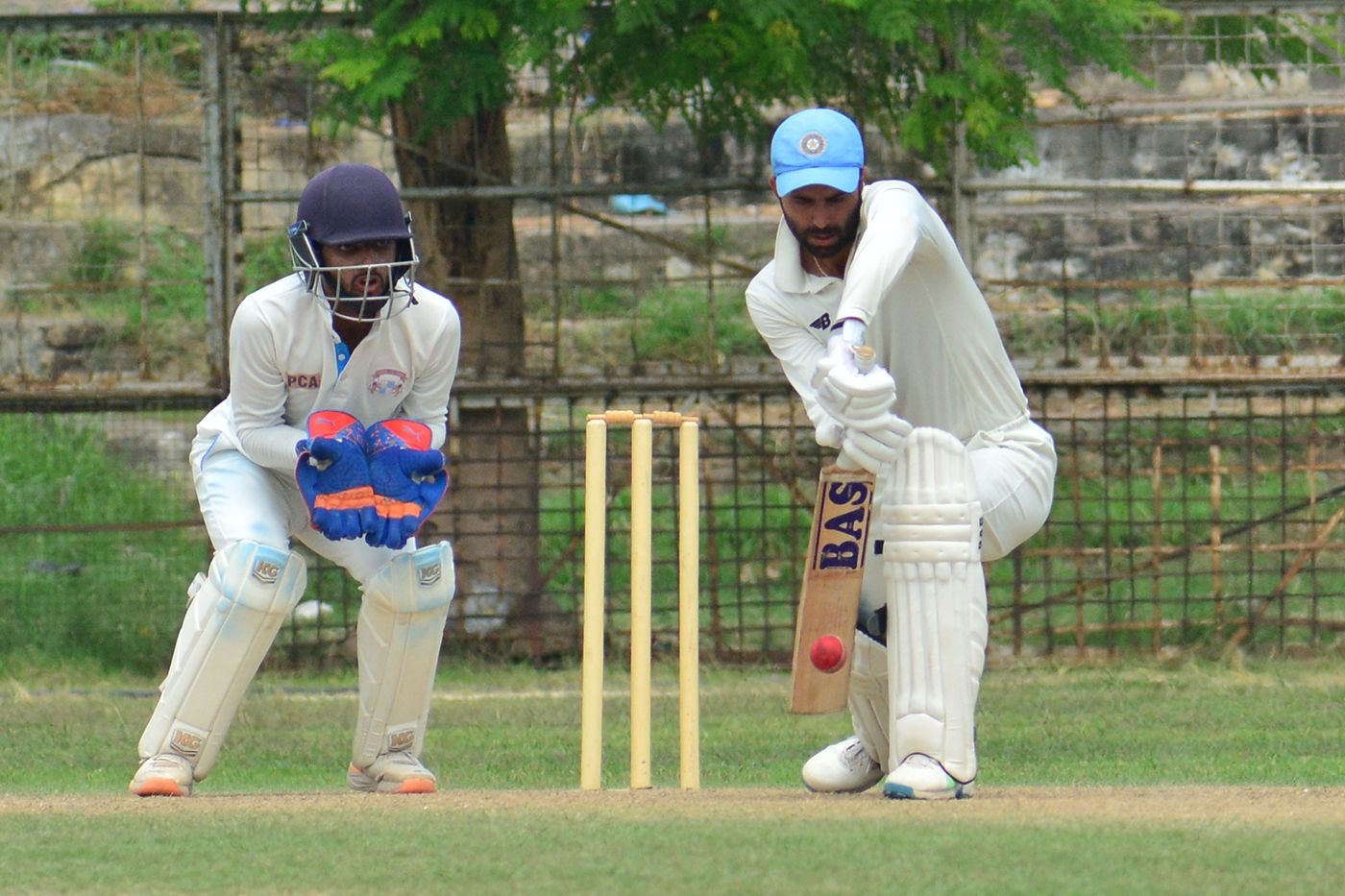 Gitansh Khera defends one as Salil Arora looks on from behind the stumps