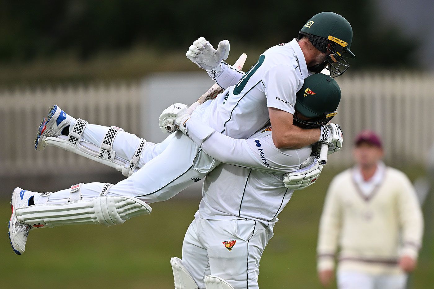 Bradley Hope leaps into Jarrod Freeman after the winning runs are scored