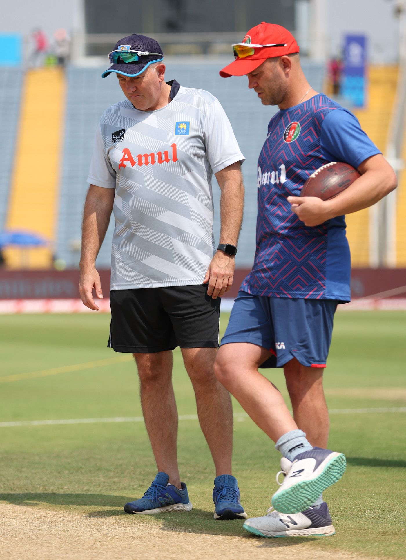 The English coaches in the mix, Chris Silverwood and Jonathan Trott, check out the pitch