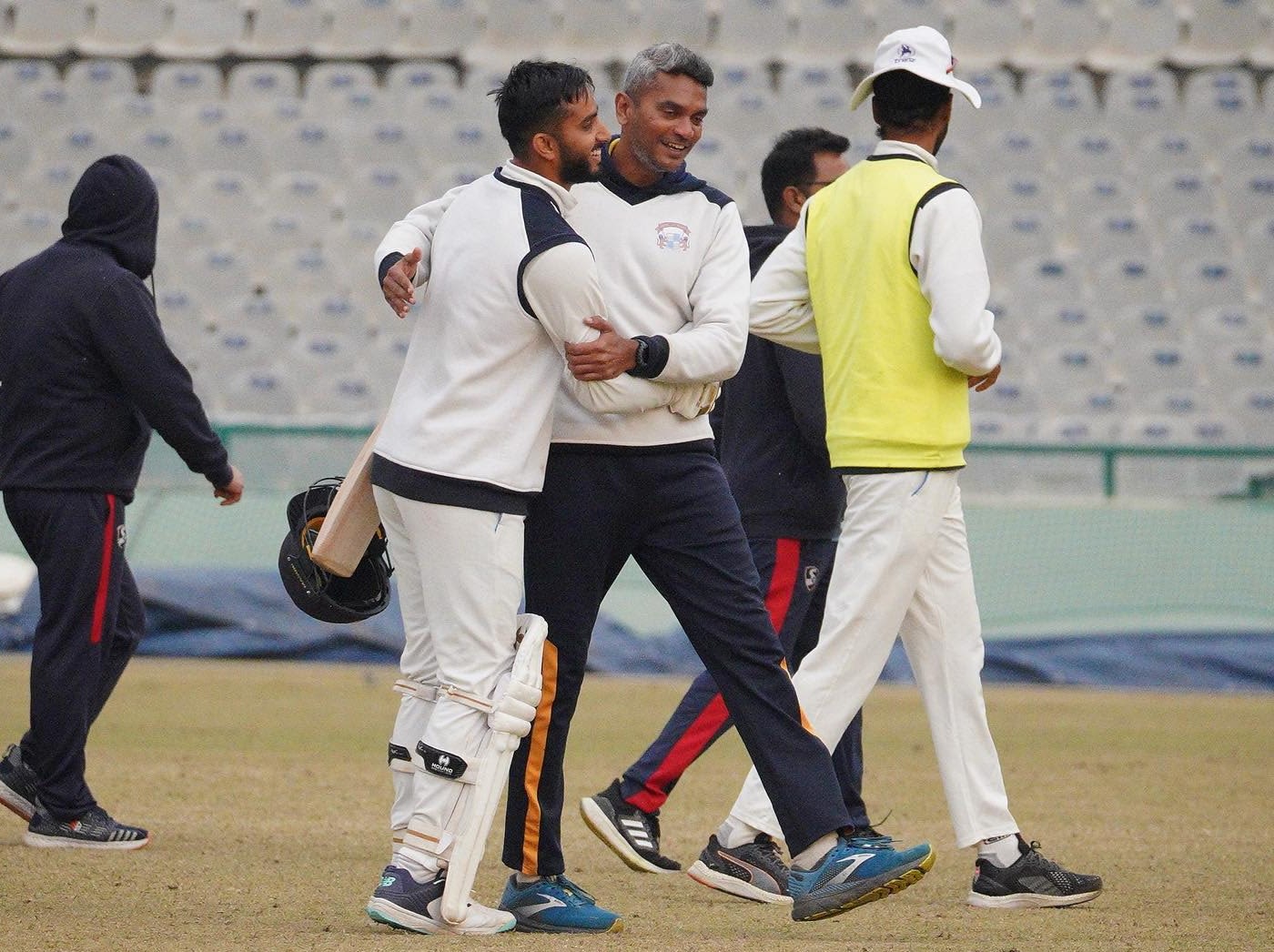 Head coach Aavishkar Salvi congratulates Mayank Markande