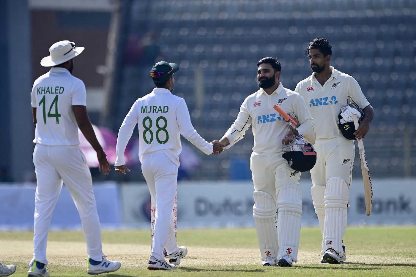 Ajaz Patel and Ish Sodhi shake hands with Hasan Murad and Khaled Ahmed after the game