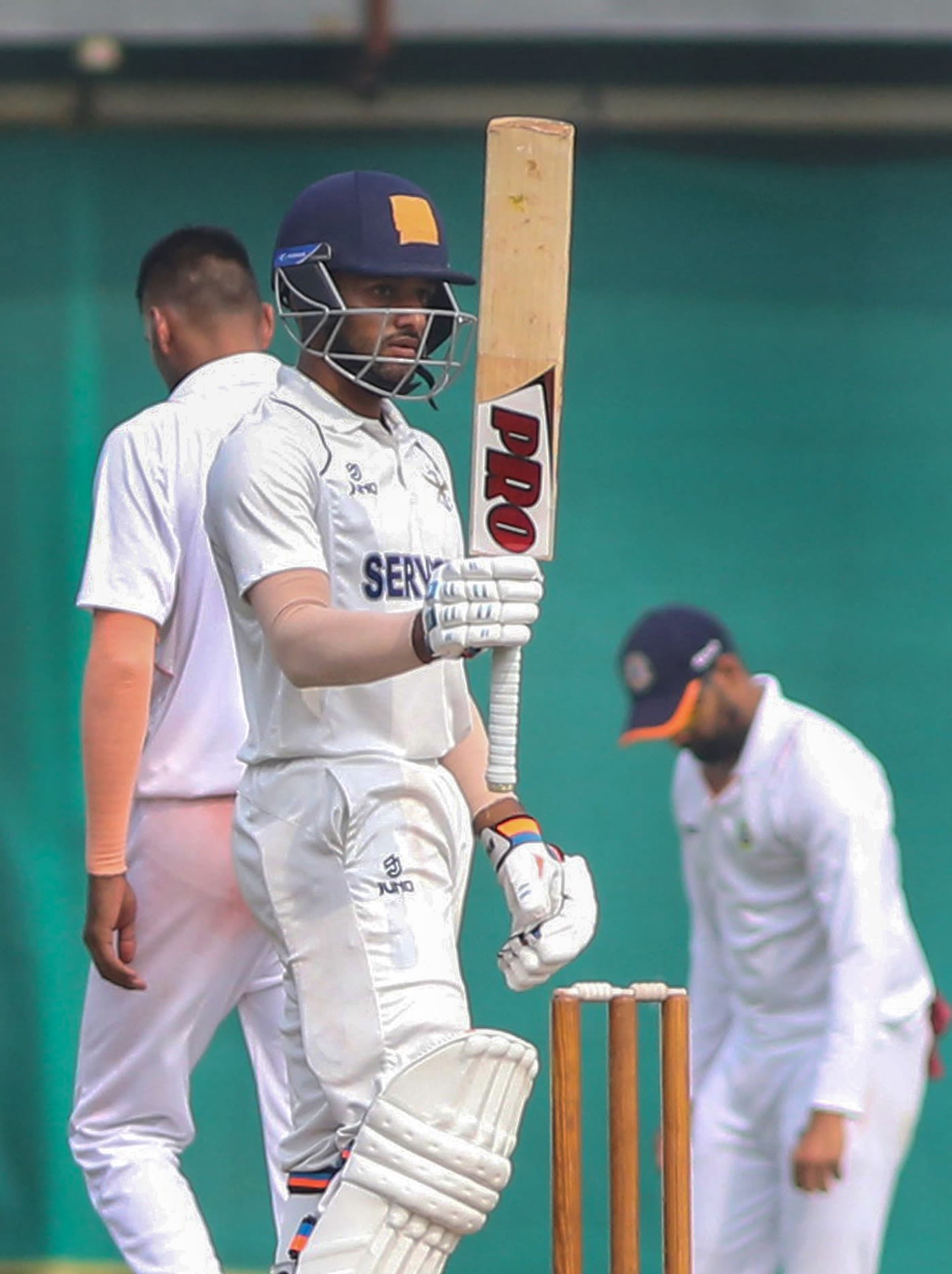 Services' Shubham Rohilla raises his bat after reaching a half-century