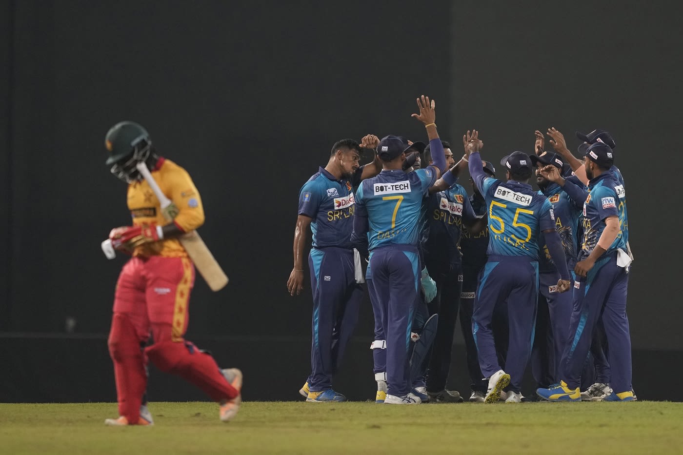 Dilshan Madushanka celebrates as Tinashe Kamunhukamwe trudges off
