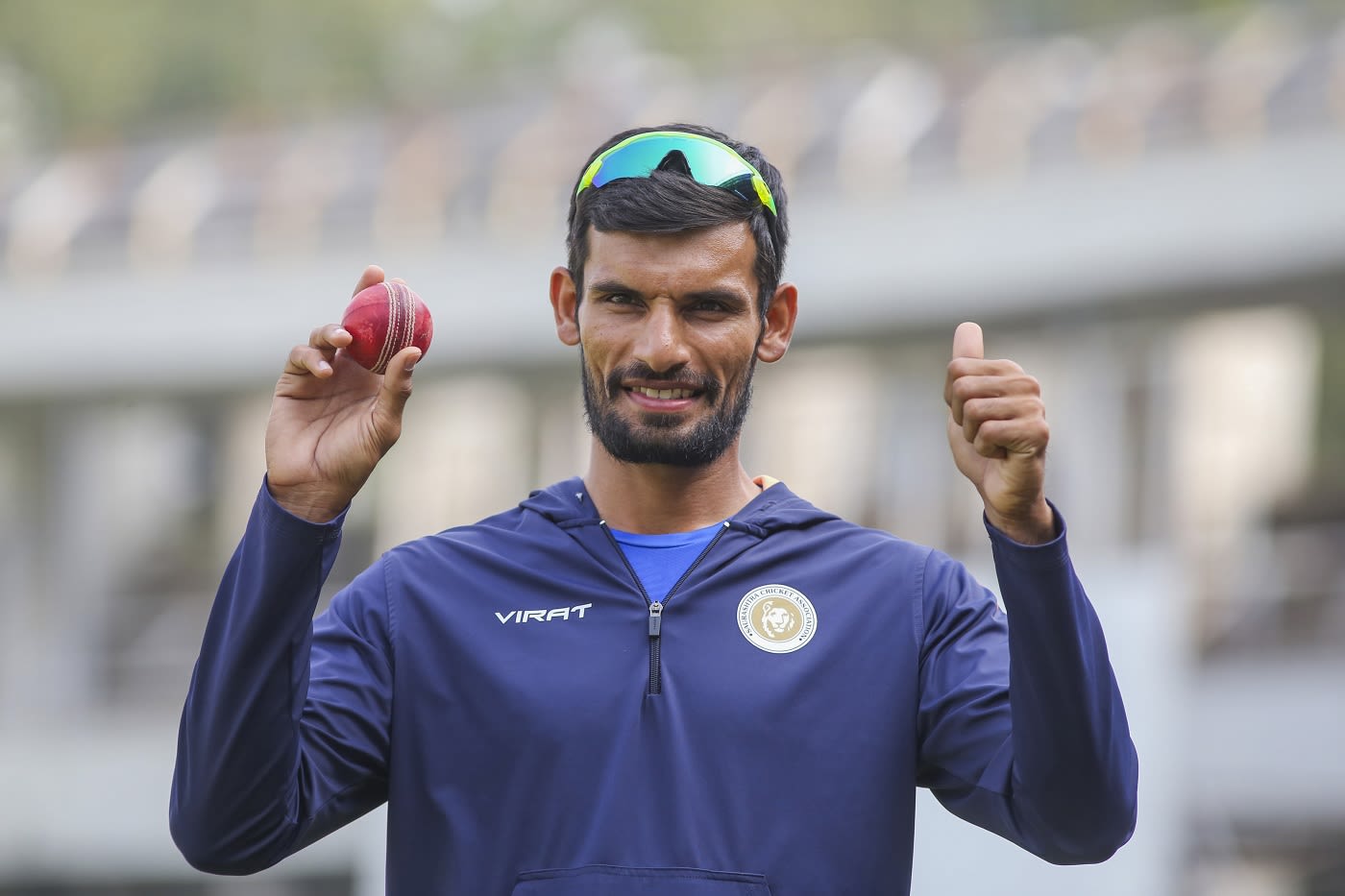 Saurashtra's Chirag Jani holds the ball up and poses