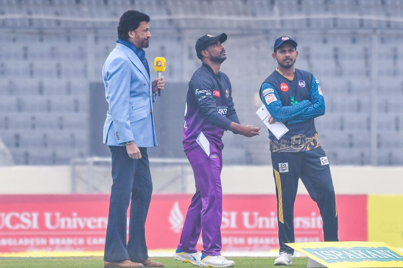 Shuvagata Hom spins the coin as Mosaddek Hossain watches on