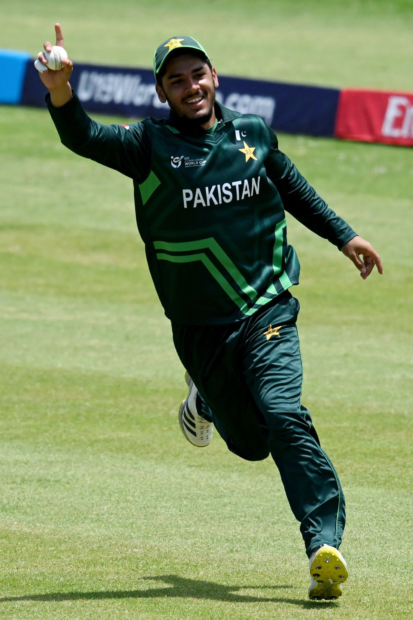 Shahzaib Khan celebrates after taking the catch to dismiss Zac Cumming