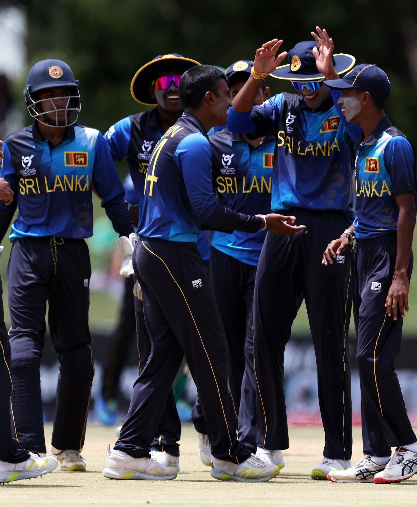 Supun Waduge celebrates a wicket with his team-mates