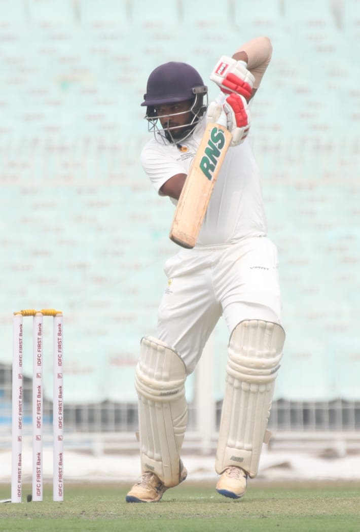 Prasad Pawar punches the ball on the off side