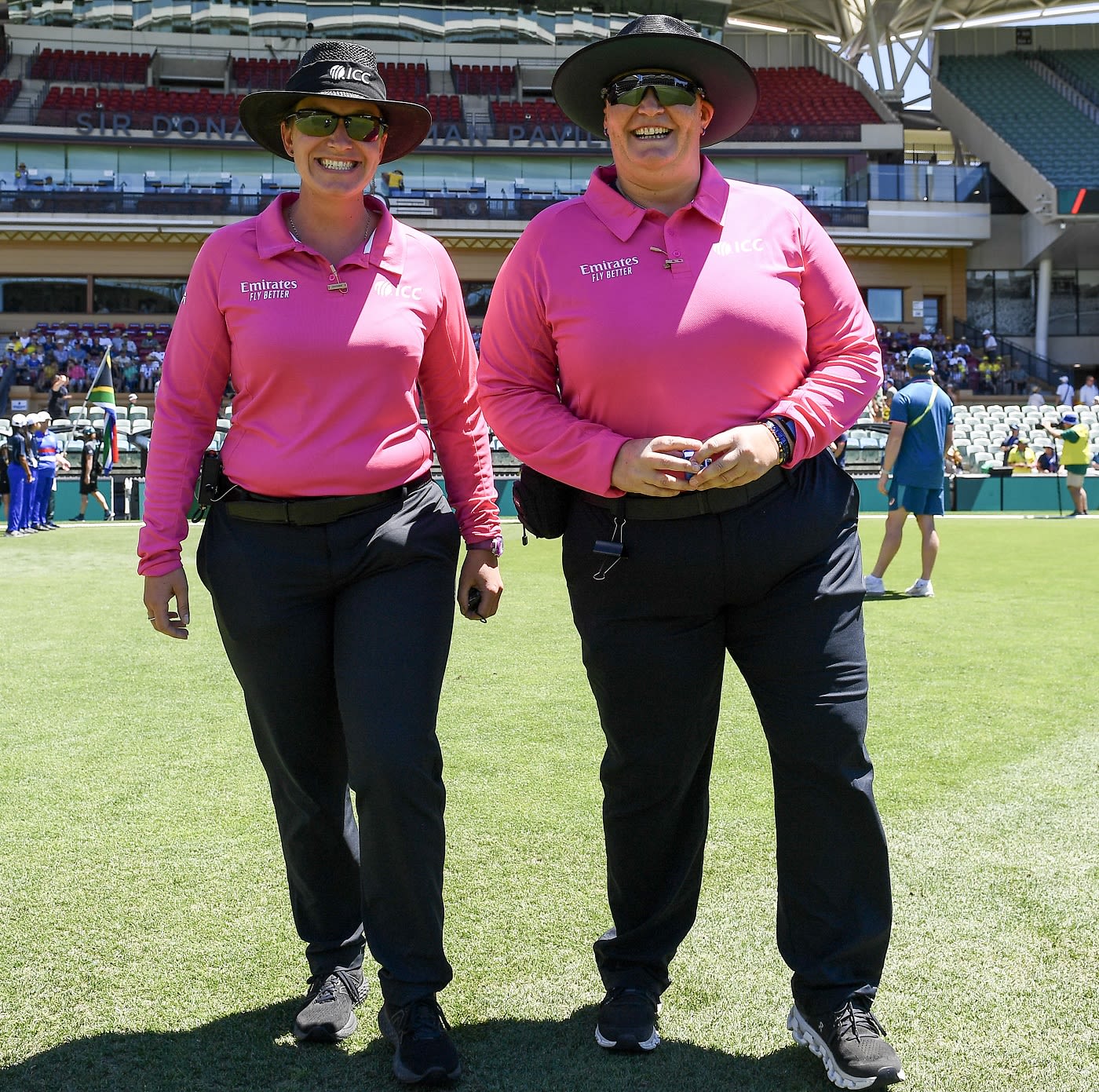 Umpires Claire Polosak and Sue Redfern are all smiles as they walk out to officiate