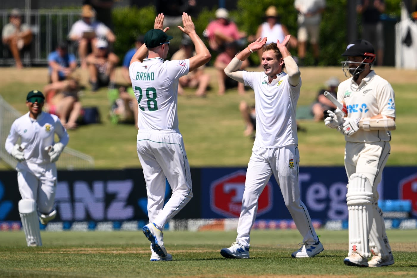 Captain Neil Brand congratulates Ryan de Swardt for removing Kane Williamson