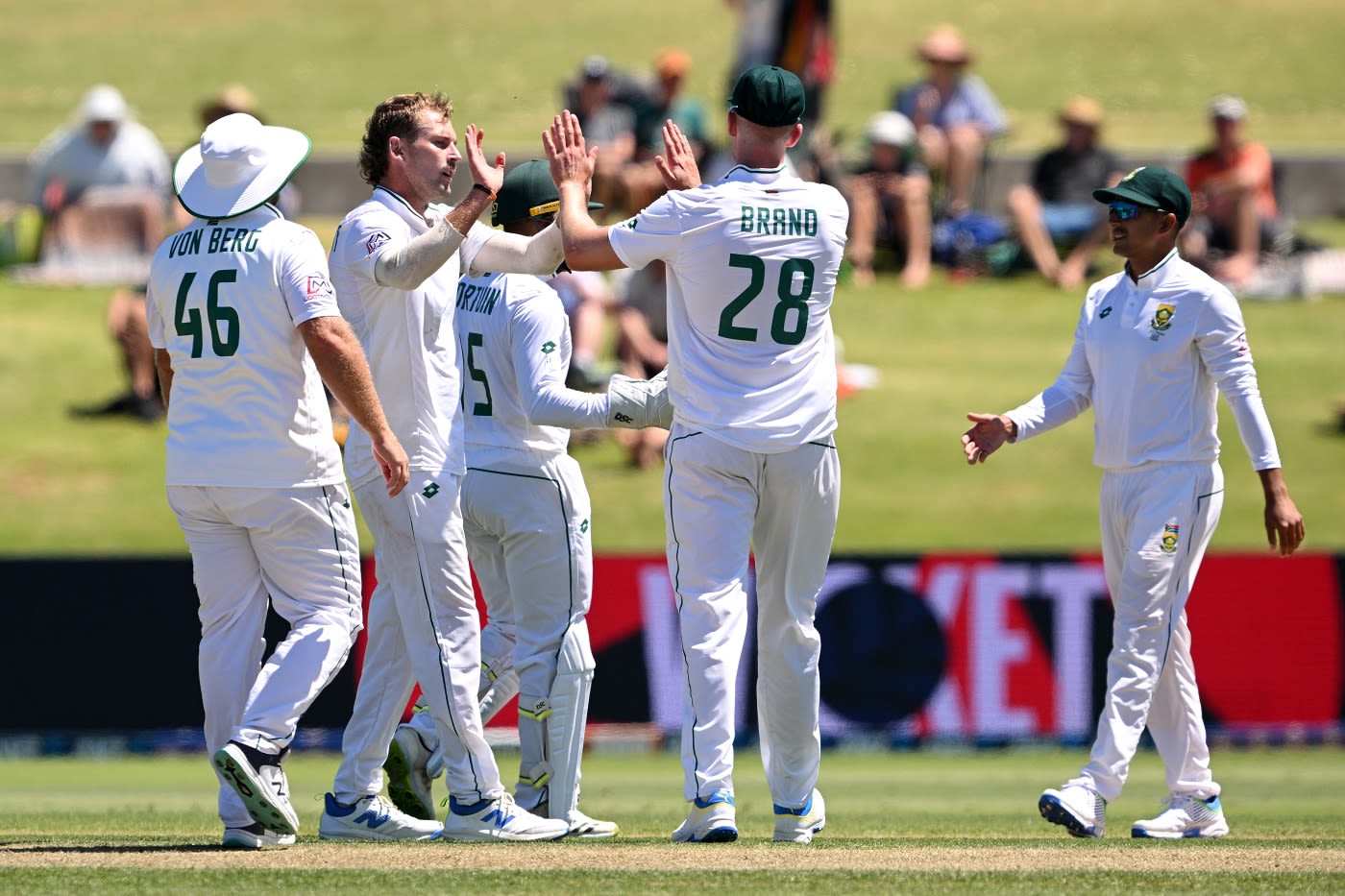 Ryan de Swardt is congratulated by team-mates after he removed Tom Blundell