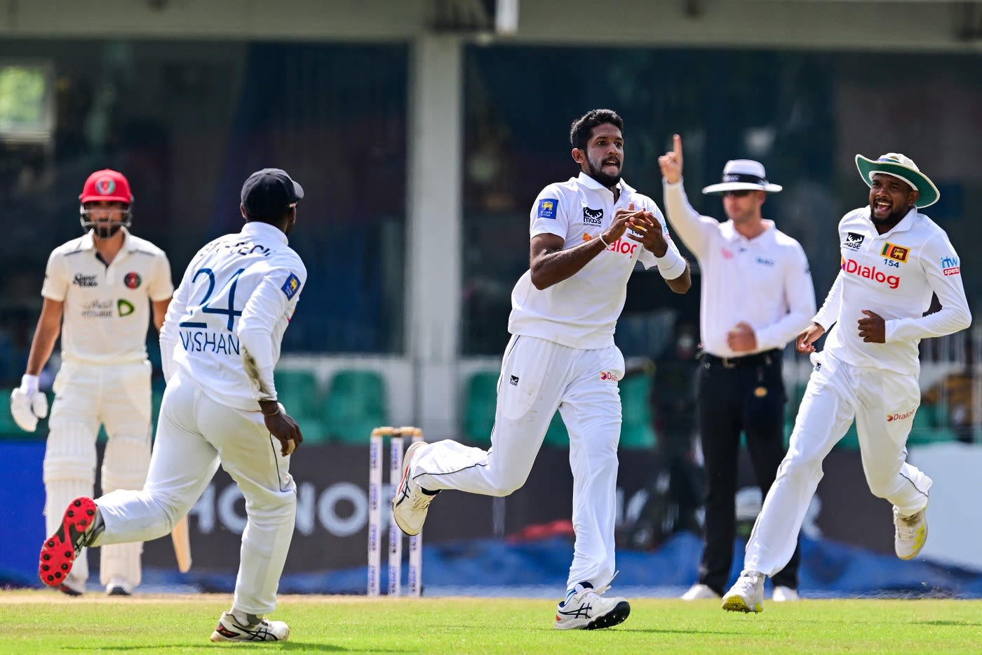 Kasun Rajitha takes off after getting Rahmat Shah and breaking the century stand