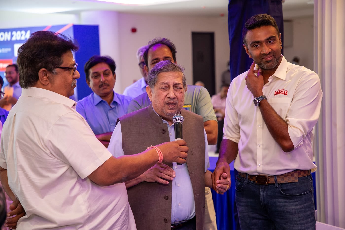 N Srinivasan, flanked by R Ashwin to his left, speaks at the TNPL auction