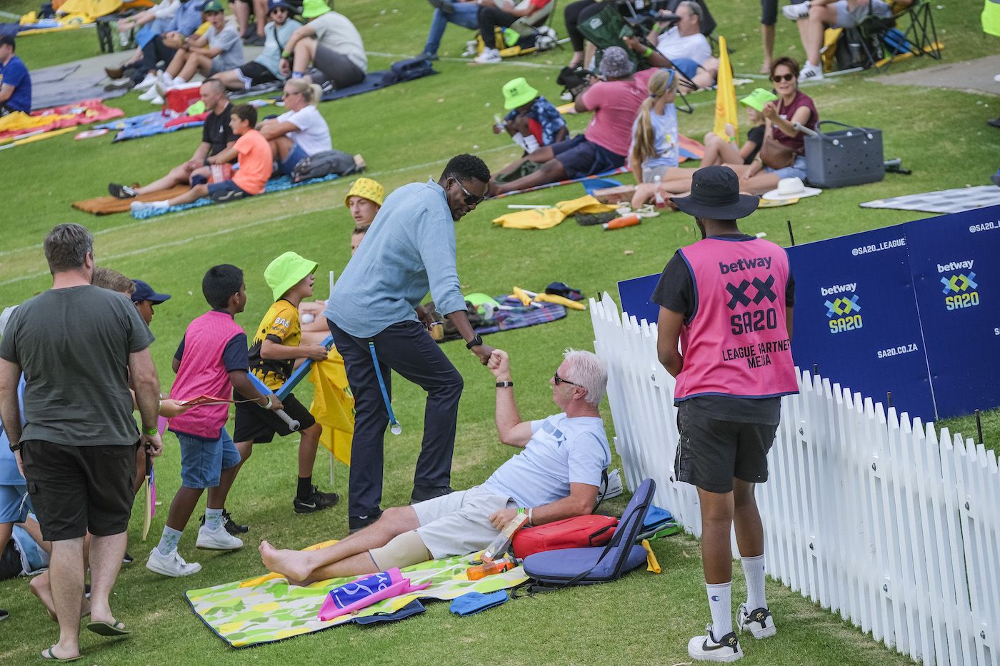 Pommie Mbangwa fistbumps a fan on the Johannesburg grass banks