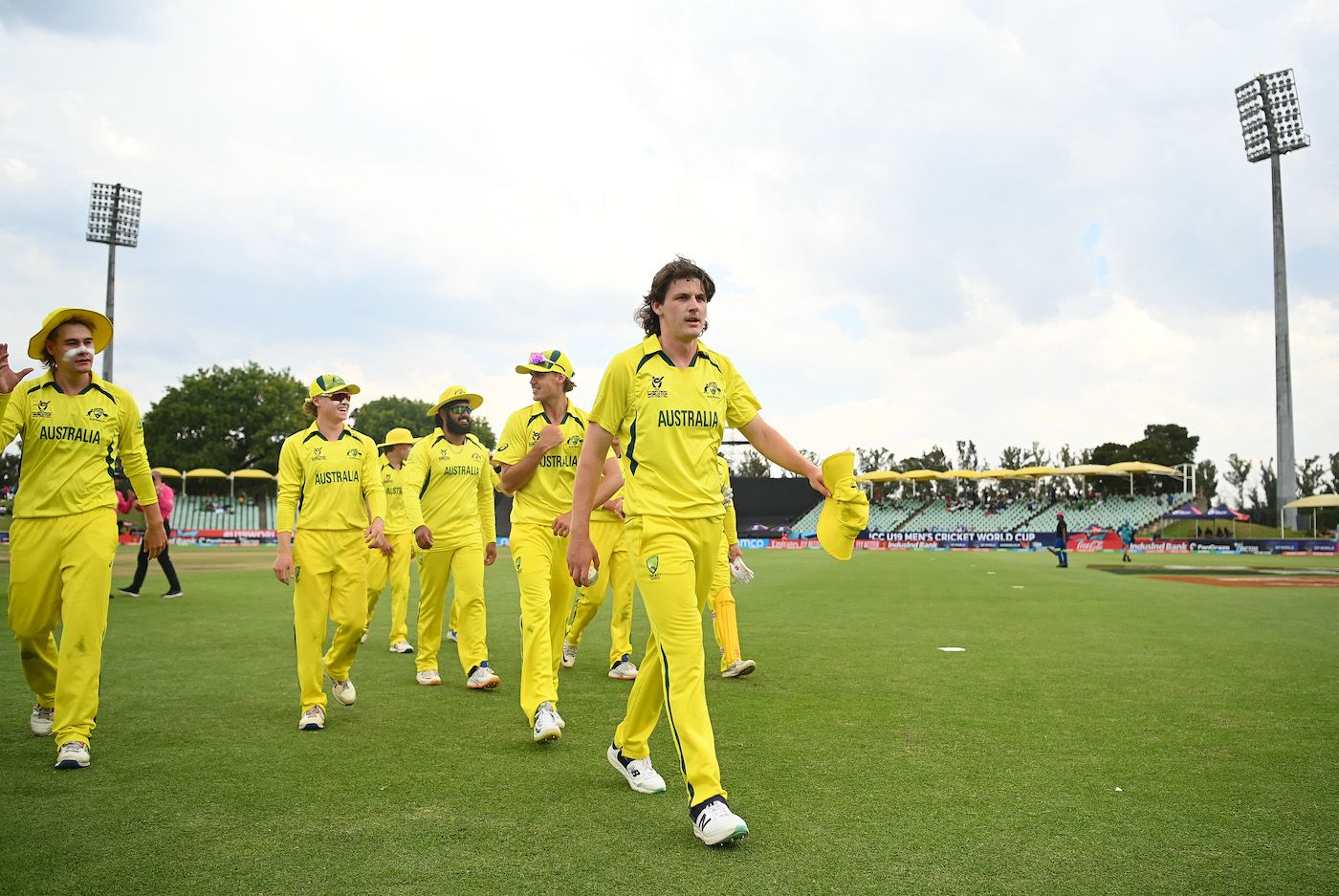 Tom Straker leads the Australians off the field