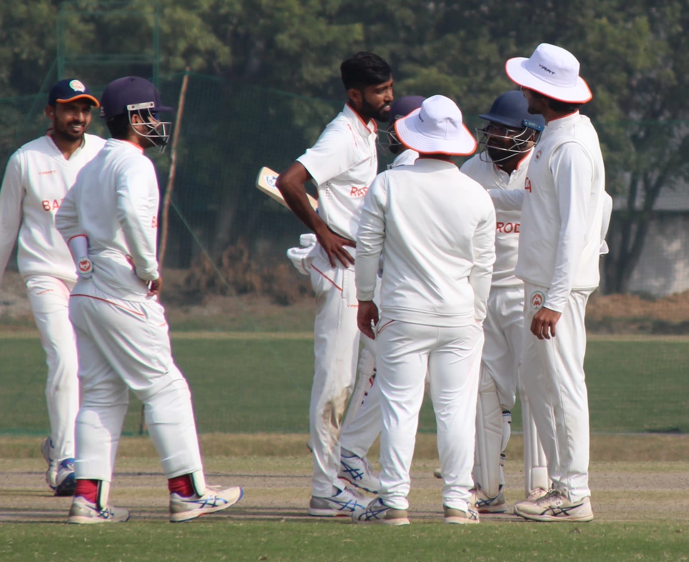 Mahesh Pithiya gets together with his team-mates after a wicket