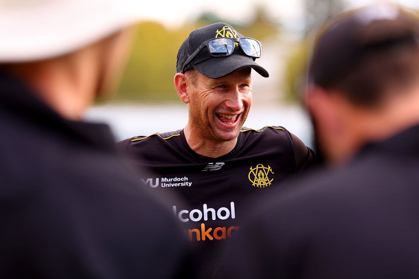 Adam Voges all smiles in a team huddle