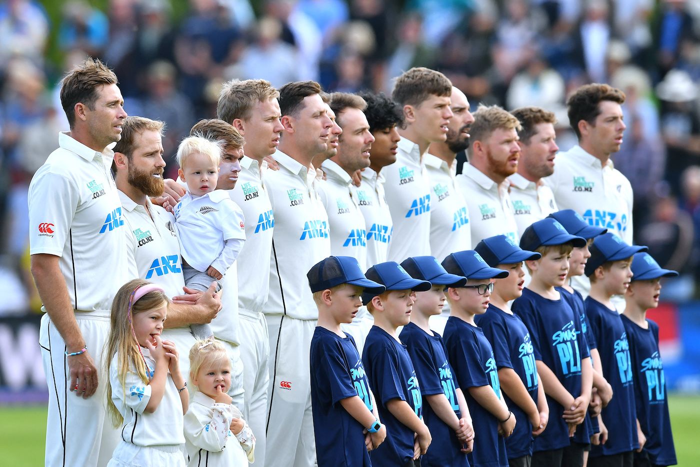Tim Southee, Kane Williamson with team-mates on their hundredth Test