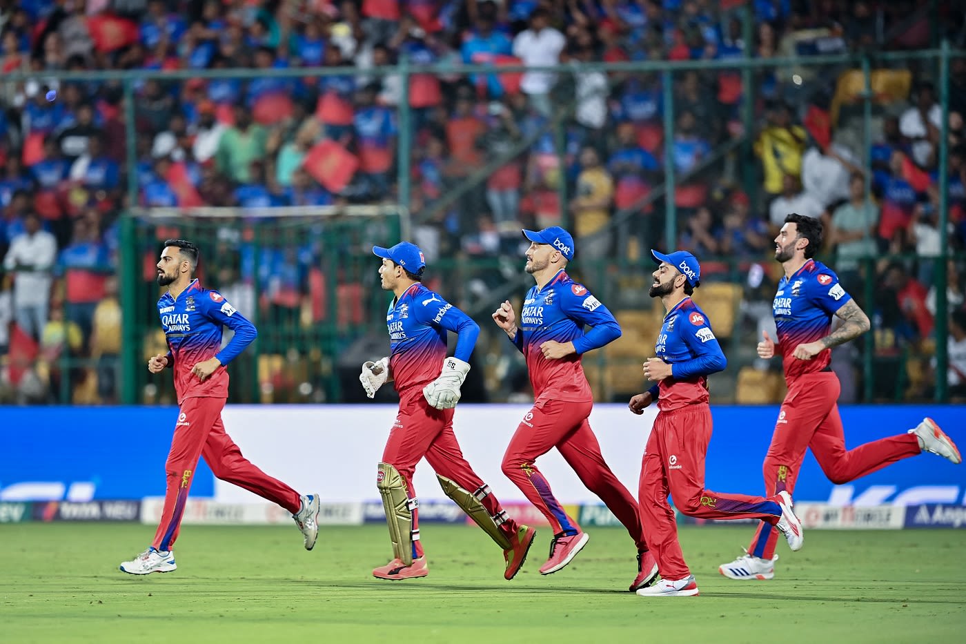 Royal Challengers Bangalore players march on to the field