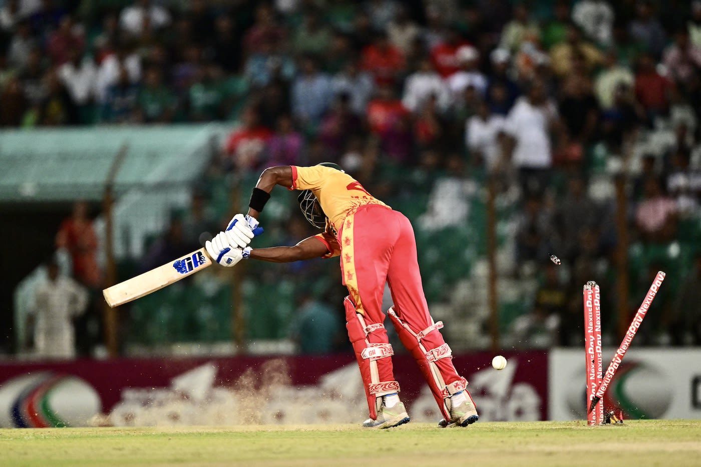 Clive Madande is bowled by a yorker