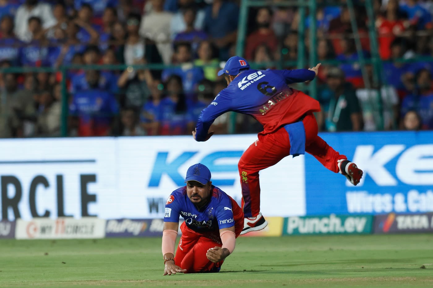 Karn Sharma takes a diving catch to dismiss Shai Hope as Mahipal Lomror avoids a collision