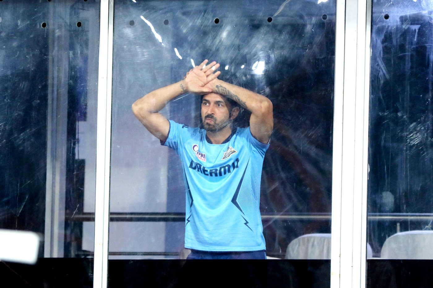 Mohit Sharma looks on while it rains