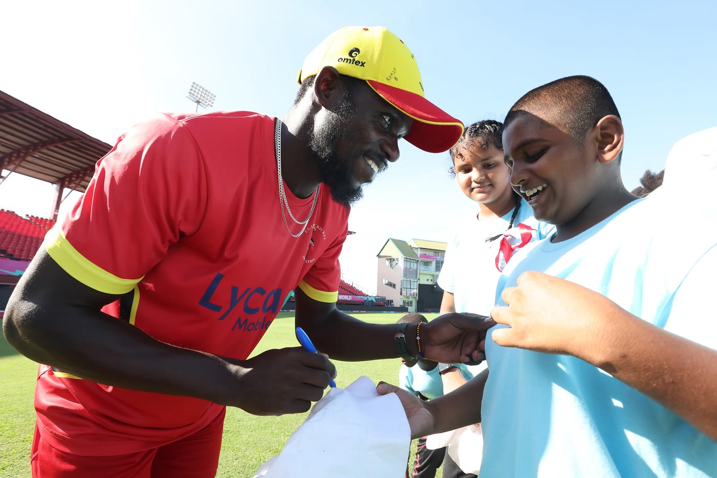 Uganda's Kenneth Waiswa signs an autograph