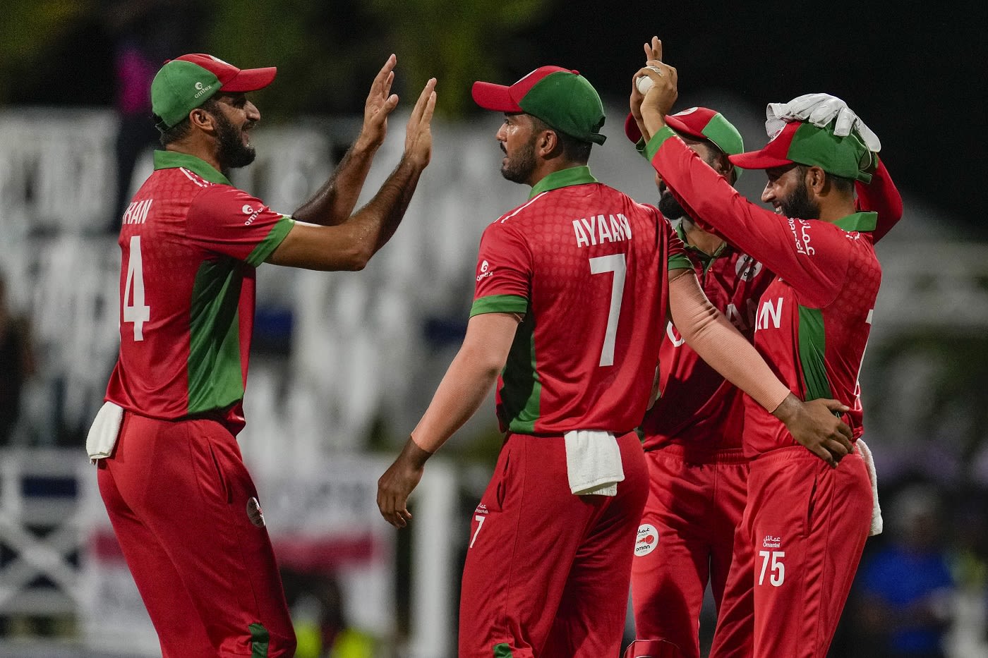 Khalid Kail (right) is congratulated by team-mates after taking the catch to dismiss Travis Head