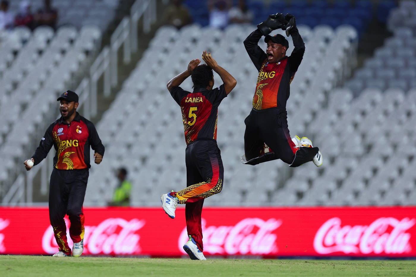 Kiplin Doriga and Semo Kamea celebrate a wicket