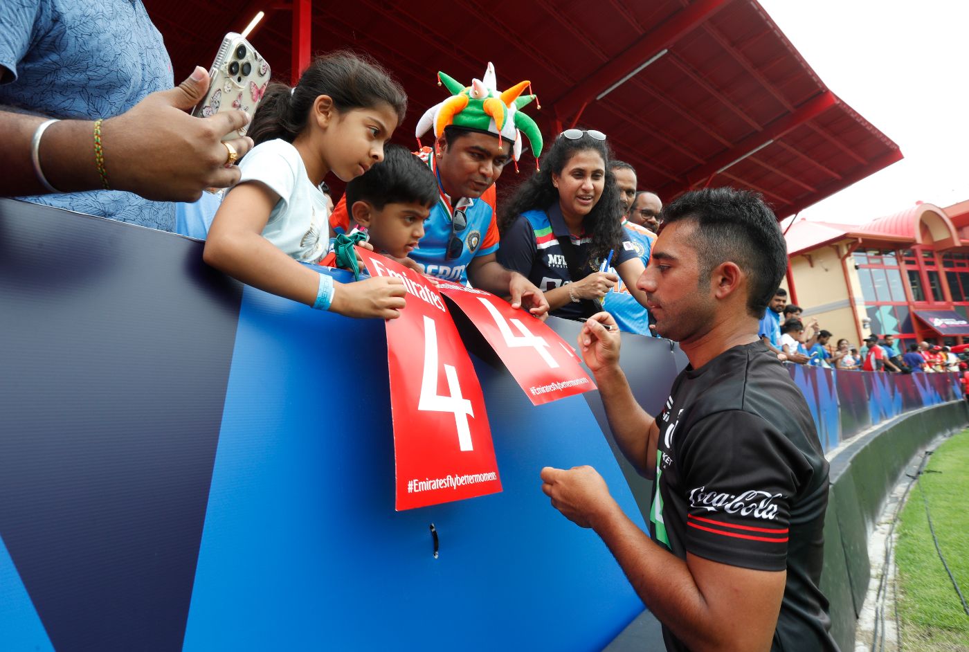 Canada captain Saad Bin Zafar signs autographs on a damp day in Lauderhill