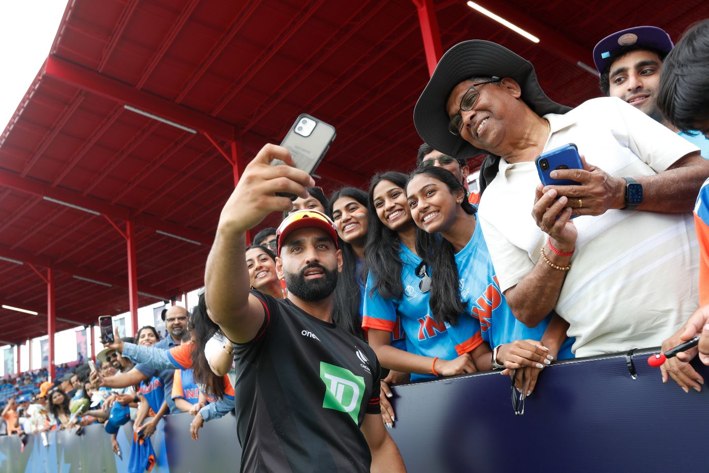 Canada's Ravinderpal Singh gives fans reasons to smile on an otherwise dreary day at the cricket