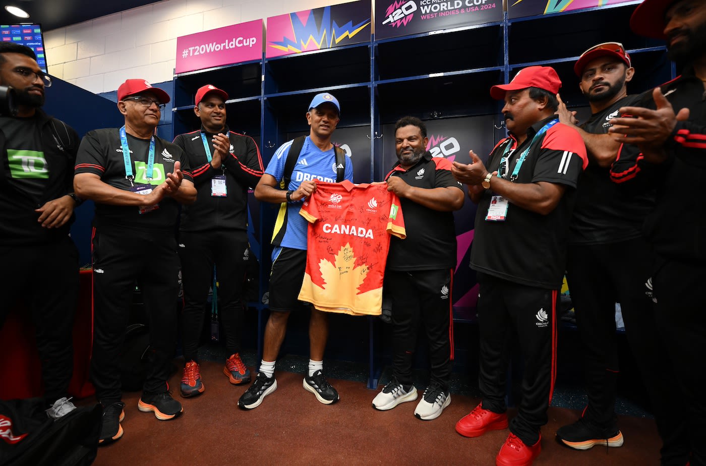 Pubudu Dassanayake presents Rahul Dravid with a Canada team shirt signed by the players