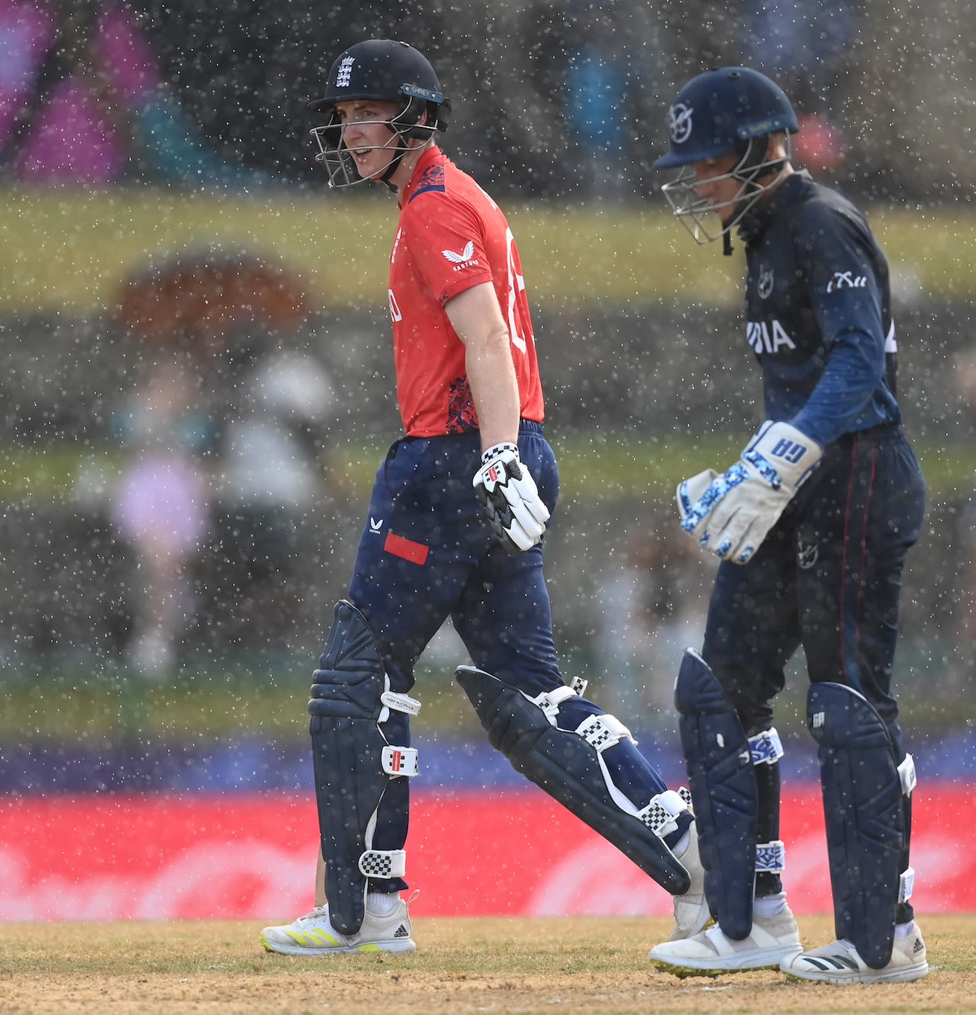 Harry Brook and Zane Green walk off as the rain returns