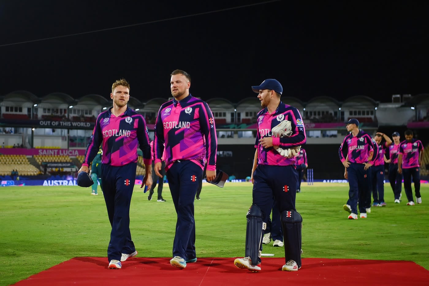 A dejected Richie Berrington, Mark Watt and Matthew Cross walk back after Scotland's loss against Australia