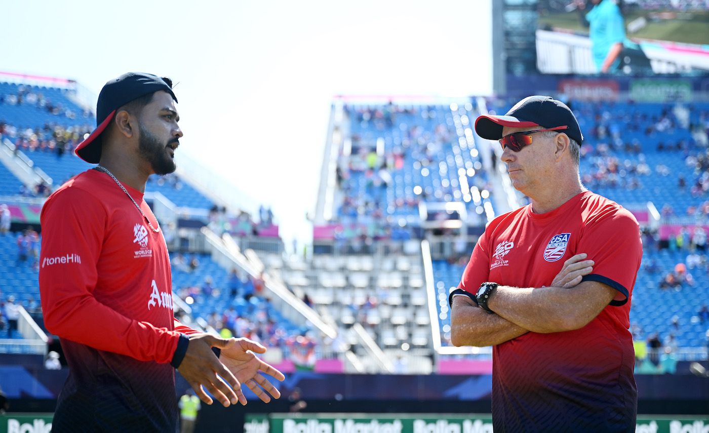 USA coach Stuart Law talks to captain Monank Patel