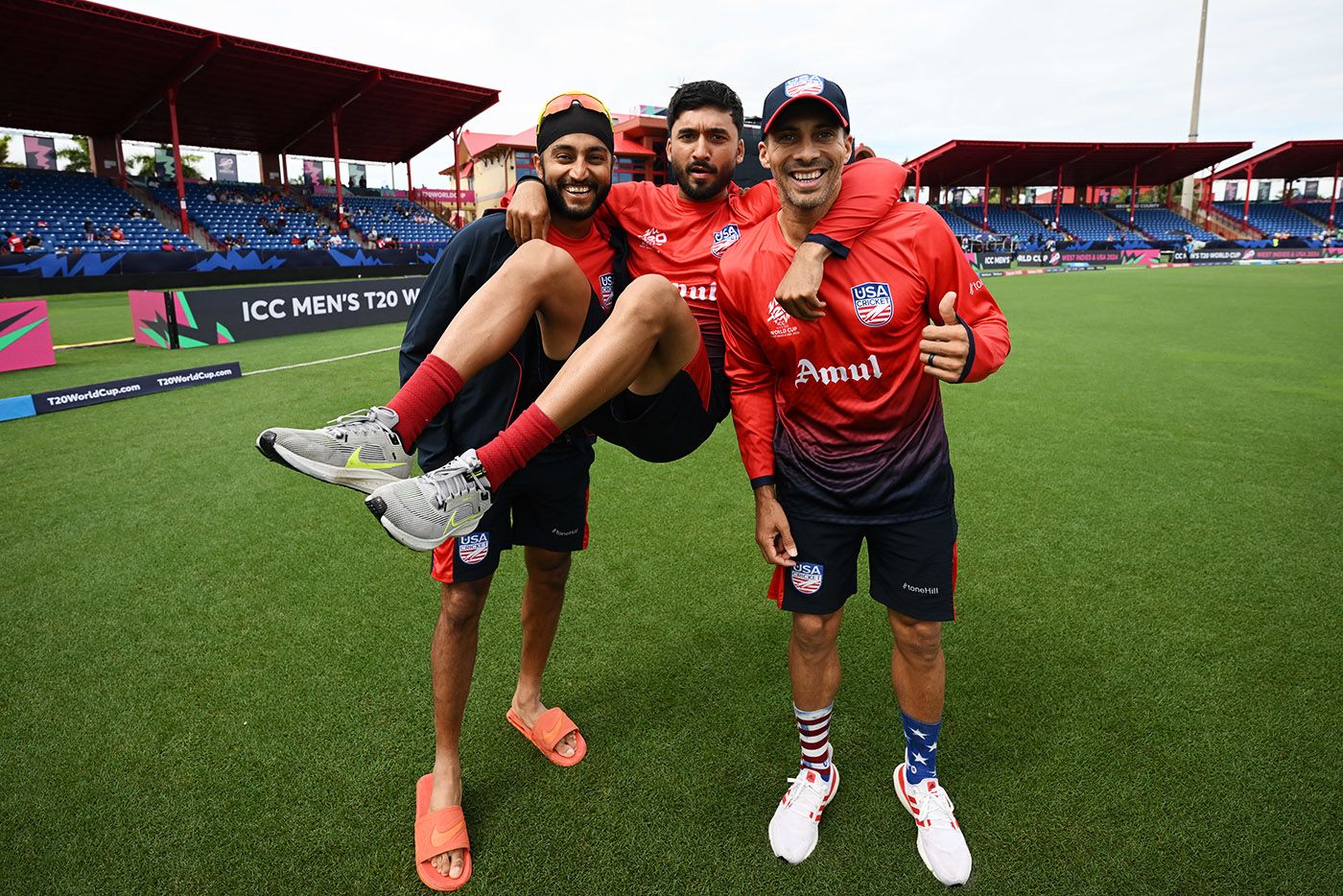 Nitish Kumar swings on the shoulders of Harmeet Singh (left) and Shadley van Schalkwyk